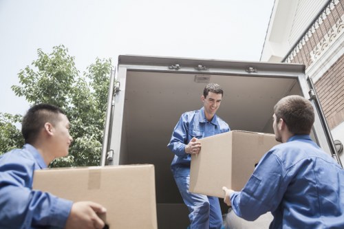 Team separating reusable furniture and recyclable waste for charity donation