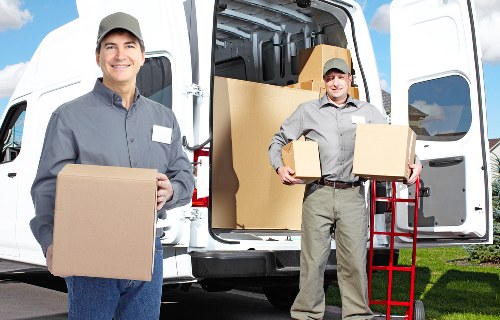 Professional movers loading items into a van in Clapham Common