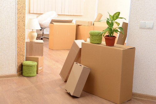 Worker wearing PPE while lifting boxes during a move