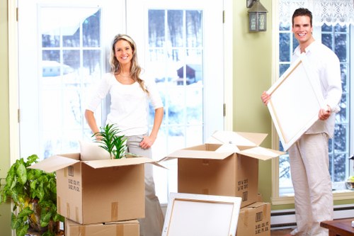Prepared boxes and furniture ready for removal in a Claphamcommon flat